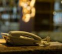 Close-up of a vintage landline phone on a marble counter in a blurred indoor setting.